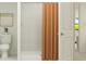 Bathroom featuring a white toilet, shower with orange curtain, and bright lighting at 1337 Acorn Meadow Loop, Eustis, FL 32726