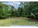 Lush backyard with mature trees creating a private and serene outdoor space at 1897 West Pkwy, Deland, FL 32724