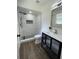 Bathroom featuring a black framed vanity and glass-enclosed shower with black hardware at 1897 West Pkwy, Deland, FL 32724