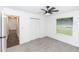 Bright bedroom featuring a ceiling fan, plush carpet, and a window allowing for natural light at 1897 West Pkwy, Deland, FL 32724