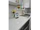 Close-up of the kitchen's countertop and stainless steel sink at 1897 West Pkwy, Deland, FL 32724