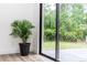 View of a bright, plant-filled corner with sliding glass doors opening onto a patio and backyard at 1897 West Pkwy, Deland, FL 32724