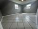 Neutral bedroom with tile floor and natural light from two large windows at 427 Donald St, Lakeland, FL 33813