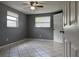 Bedroom with tiled floors, neutral paint, and a ceiling fan, offering comfort and style at 427 Donald St, Lakeland, FL 33813