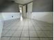 Bedroom with tiled floors, neutral paint, and a view into the hallway at 427 Donald St, Lakeland, FL 33813