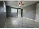 Bedroom featuring tiled floors, neutral paint, and a closet for storage and organization at 427 Donald St, Lakeland, FL 33813