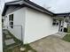 Side view of home showing white siding, a gray roof, and a fenced-in yard at 427 Donald St, Lakeland, FL 33813