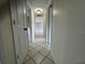 Bright hallway featuring ceramic tiles and doors, freshly painted in a light neutral color at 427 Donald St, Lakeland, FL 33813