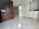 Tile floors in laundry area with washer, dryer and wooden cabinets at 427 Donald St, Lakeland, FL 33813