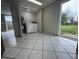 Bright laundry room with tile floors, washer, dryer, and access to the backyard at 427 Donald St, Lakeland, FL 33813