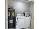 Cozy laundry area with a standard washer and dryer setup, plus water heater at 427 Donald St, Lakeland, FL 33813