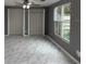 Living room with gray walls, ceiling fan and large window at 427 Donald St, Lakeland, FL 33813