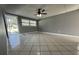 Bright, airy living room with tile floors, ceiling fan, and large window at 427 Donald St, Lakeland, FL 33813