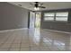 Well-lit living room with tile flooring, ceiling fan, and ample natural light at 427 Donald St, Lakeland, FL 33813