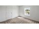 Cozy bedroom with carpet, natural light, and a large window that provides a view of the outdoors at 571 Bay Leaf Dr, Poinciana, FL 34759