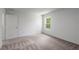 Bright bedroom with neutral carpet and a window that provides natural light and outdoor views at 571 Bay Leaf Dr, Poinciana, FL 34759