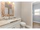 Well-lit bathroom featuring a unique mirror and granite countertop, perfect for modern living at 6214 Elm E Sq, Lakeland, FL 33813