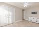 Bright bedroom featuring neutral walls, tile floors, a ceiling fan and a closet with white doors at 6214 Elm E Sq, Lakeland, FL 33813