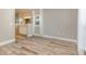 Spacious bedroom with wood-look tile flooring and view of the ensuite bathroom with white cabinets at 6214 Elm E Sq, Lakeland, FL 33813