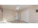 This bedroom has a ceiling fan, closet, tiled floors, and fresh paint at 6214 Elm E Sq, Lakeland, FL 33813