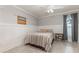 Comfortable bedroom featuring neutral walls, wainscoting, and a bright window at 6214 Elm E Sq, Lakeland, FL 33813