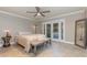 Bedroom featuring access to a pool through French doors and neutral decor with tile flooring at 6214 Elm E Sq, Lakeland, FL 33813