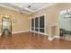 Bright dining room featuring a modern light fixture, large windows, and elegant flooring at 6214 Elm E Sq, Lakeland, FL 33813