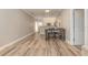 Bright dining area featuring wood-look tile flooring, gray table with chairs, and open access to the kitchen at 6214 Elm E Sq, Lakeland, FL 33813