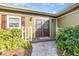 Inviting front entrance of a home featuring double doors, decorative windows, and brick walkway at 6214 Elm E Sq, Lakeland, FL 33813