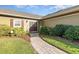 Beautiful front entryway of a home with a brick path, and a set of double doors at 6214 Elm E Sq, Lakeland, FL 33813