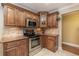 Close up kitchen shot with stainless steel appliances, granite countertops and wooden cabinetry at 6214 Elm E Sq, Lakeland, FL 33813