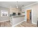 Charming kitchenette with white cabinets, pendant lighting, and modern appliances at 6214 Elm E Sq, Lakeland, FL 33813