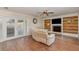 Inviting living room boasting hardwood floors, built-in shelving, and a cozy fireplace at 6214 Elm E Sq, Lakeland, FL 33813