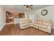 Open concept living room featuring tile floors, a sectional sofa, and a view into the kitchen at 6214 Elm E Sq, Lakeland, FL 33813