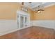 Elegant living room featuring crown molding, and glass doors, creating a bright atmosphere at 6214 Elm E Sq, Lakeland, FL 33813