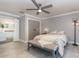 Cozy main bedroom features a ceiling fan, walk-in closet, and access to the ensuite bathroom at 6214 Elm E Sq, Lakeland, FL 33813