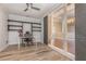 Sunlit office with modern lighting, wooden shelves, and large glass sliding doors to another room at 6214 Elm E Sq, Lakeland, FL 33813