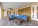 Covered patio with wicker furniture and a ceiling fan, creating a cozy outdoor living space at 6214 Elm E Sq, Lakeland, FL 33813