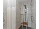 Modern walk-in shower features marble tile, a built-in shelf, and a handheld shower head at 6214 Elm E Sq, Lakeland, FL 33813