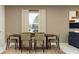 Dining room with a large window, modern art, stylish furniture and neutral tones at 942 Hour Glass Rd, Lakeland, FL 33801