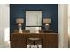 This is a home office design, showing a desk, chair, and lamps set in front of a dark blue wall at 942 Hour Glass Rd, Lakeland, FL 33801