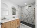 Bathroom featuring double vanities and a beautifully tiled walk-in shower with designer finishes at 2015 Poe St, Lakeland, FL 33801