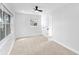 Bright bedroom featuring neutral carpet, white walls, and a large window overlooking the yard at 2015 Poe St, Lakeland, FL 33801