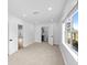 Bright bedroom with neutral carpet, white walls, and natural light from the large window at 2015 Poe St, Lakeland, FL 33801