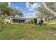 Expansive backyard featuring a screened patio, and mature trees at 2640 Oak Dr, Bartow, FL 33830