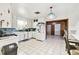 Classic kitchen featuring tile flooring, white cabinetry, and an adjacent dining area at 2640 Oak Dr, Bartow, FL 33830