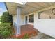 Charming covered front porch with decorative railings and a tiled landing at 2640 Oak Dr, Bartow, FL 33830