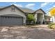 Charming one-story home with a well-maintained lawn, beautiful trees, and a gray tile roof at 1310 Patricia St, Kissimmee, FL 34744