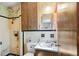 Dated bathroom featuring yellow and black tiling, vanity, and shower at 220 Hillside Dr, Lakeland, FL 33803