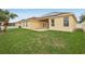 Backyard featuring a lawn, the house and a patio; solar panels on the roof at 2726 Herons Landing Dr, Kissimmee, FL 34741